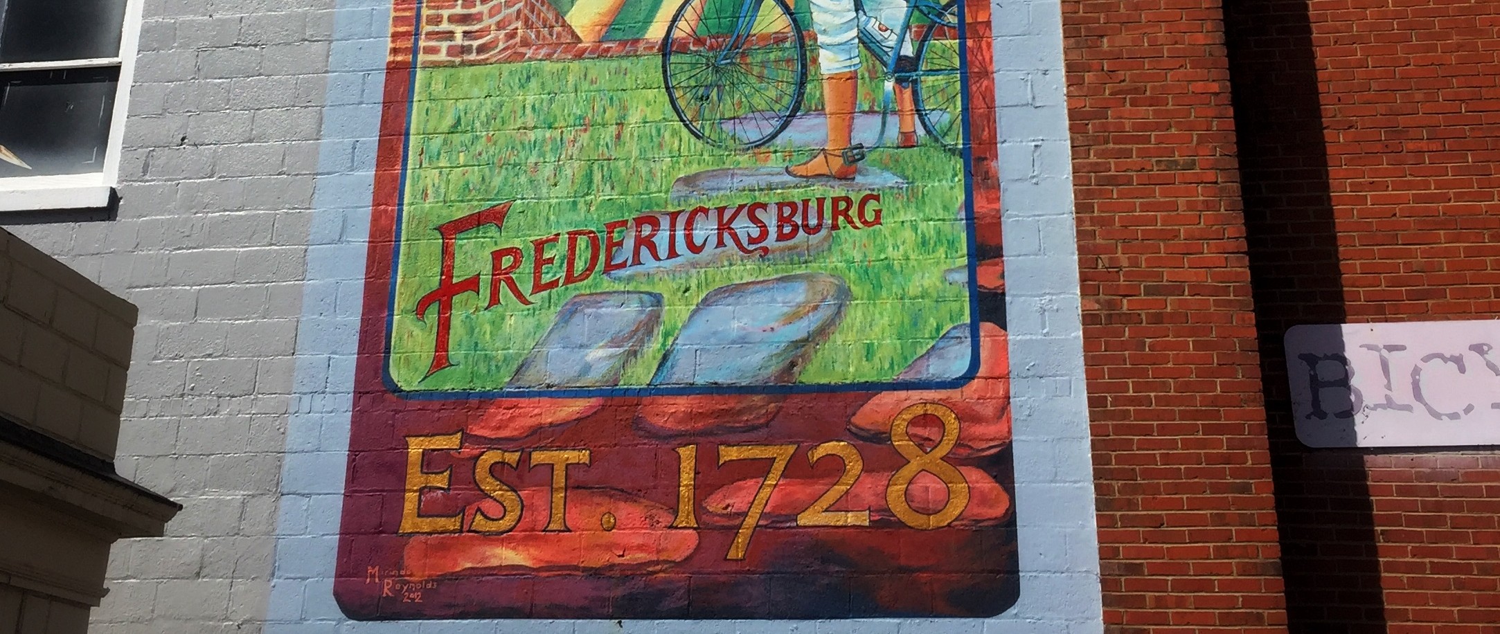 Downtown Fredericksburg, VA mural that says, Fredericksburg, estabished 1728.