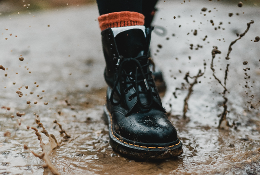 combat boot stomping in a rain puddle