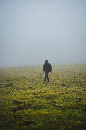 man walking in fog